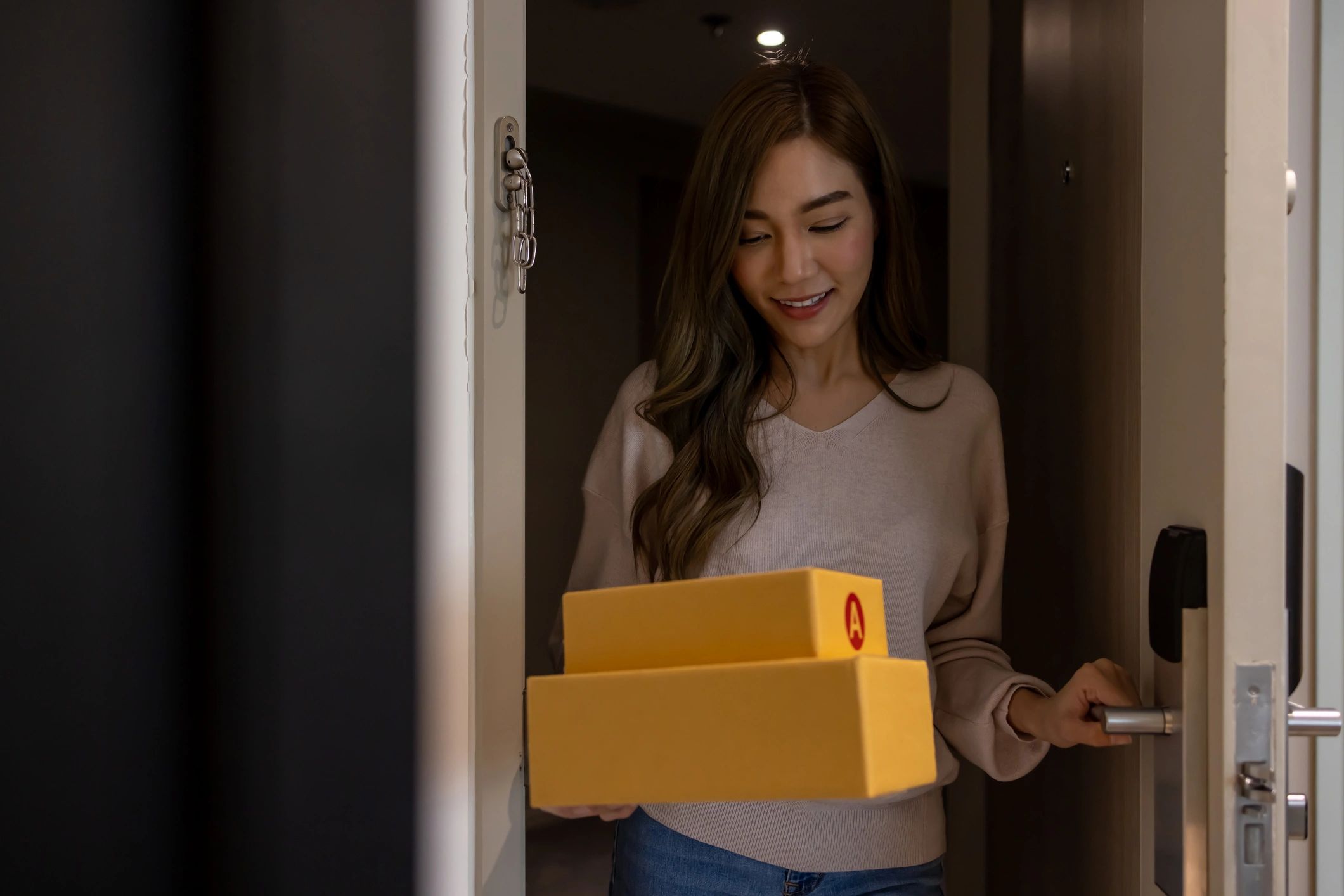 Customer holding packages at a front door